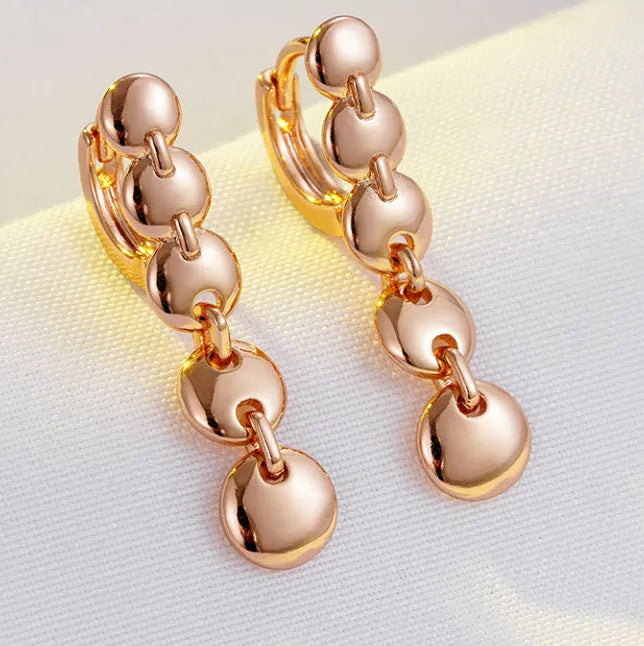 Gold retro woven hoop earrings showing full circle and textured copper surface