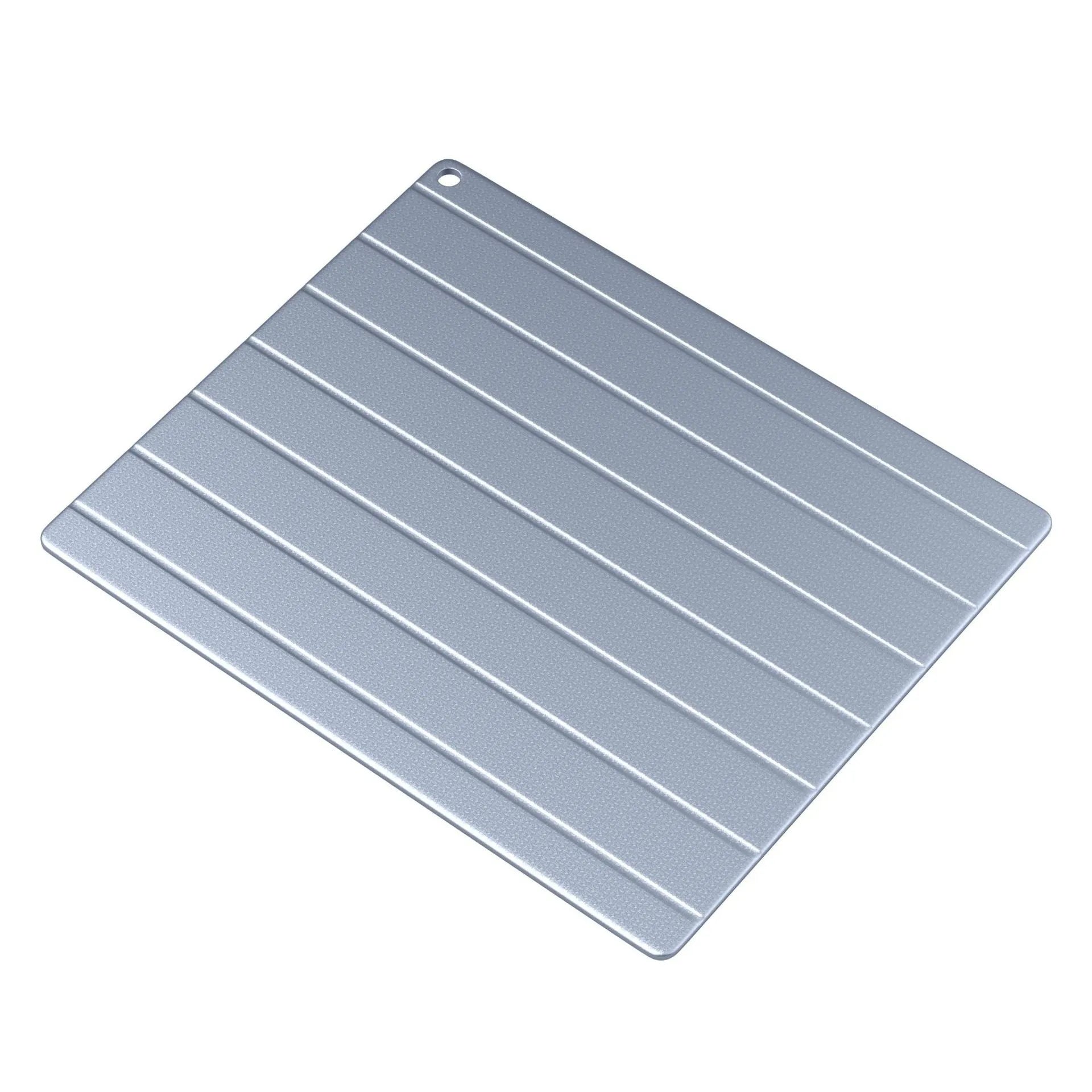 Aluminium household quick defrosting plate on a kitchen countertop, showing modern simplicity style.