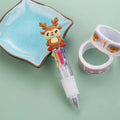 Christmas-themed ballpoint pen with press button, showing designs of snowmen, reindeer, and trees on plastic barrel.