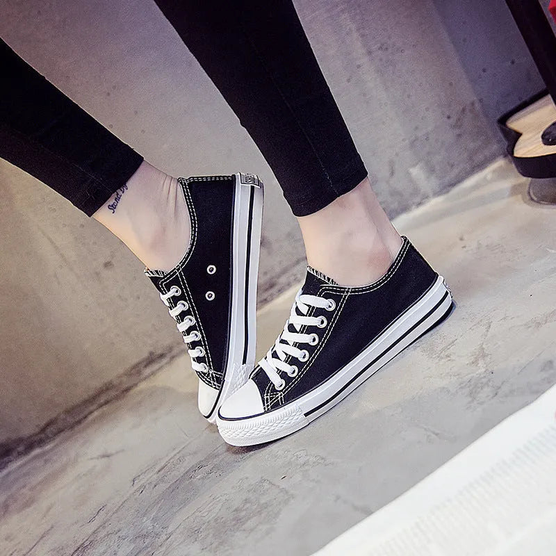 Women's canvas shoes in solid colours including black, white-black, white-red, and all-black variations