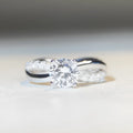 Silver geometric cross ring with 1 karat moissanite stone and twisted band