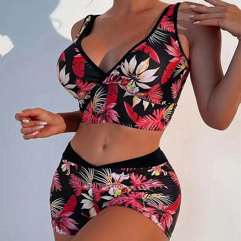 Women's two-piece swimsuit set with sleeveless top and printed boxer-style bottoms in a multi-colour pattern.