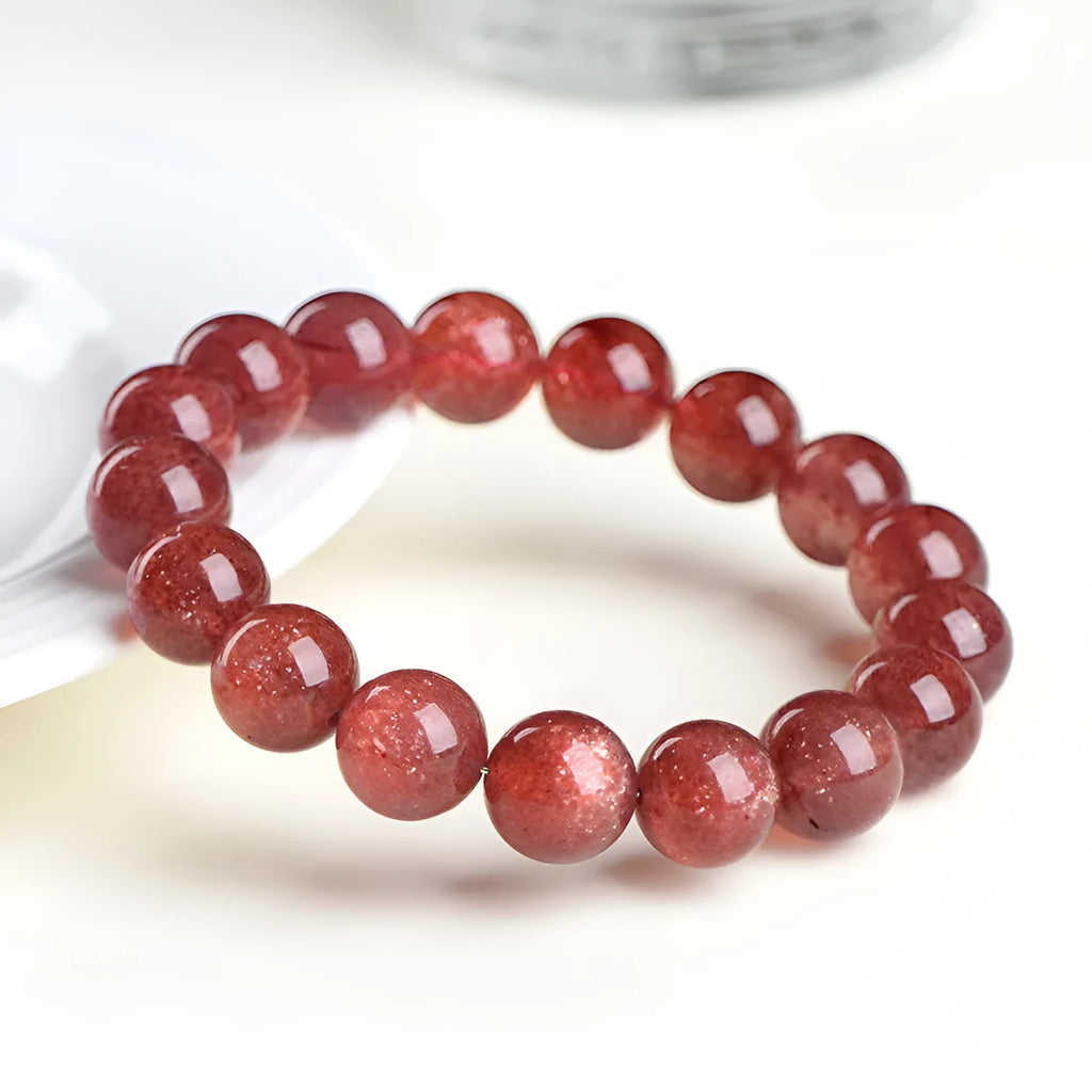 Natural strawberry quartz bracelet with geometric red crystal beads in three size options from 7mm to 10.8mm diameter