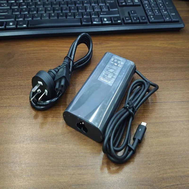 Black 65W Type-C laptop power adapter with multiple international power plugs