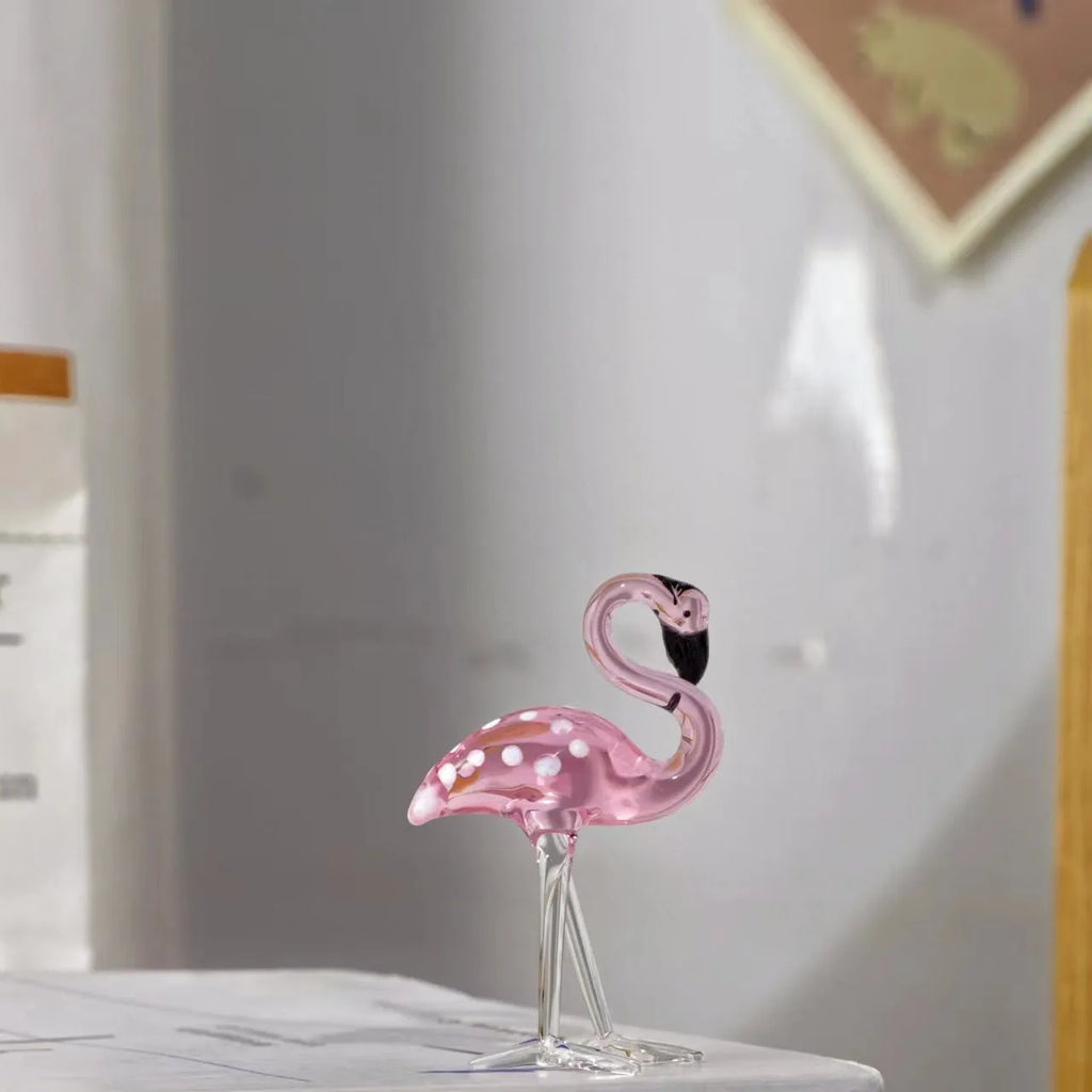 Pink crystal flamingo decorative ornament on table, available in separate or parallel styles.