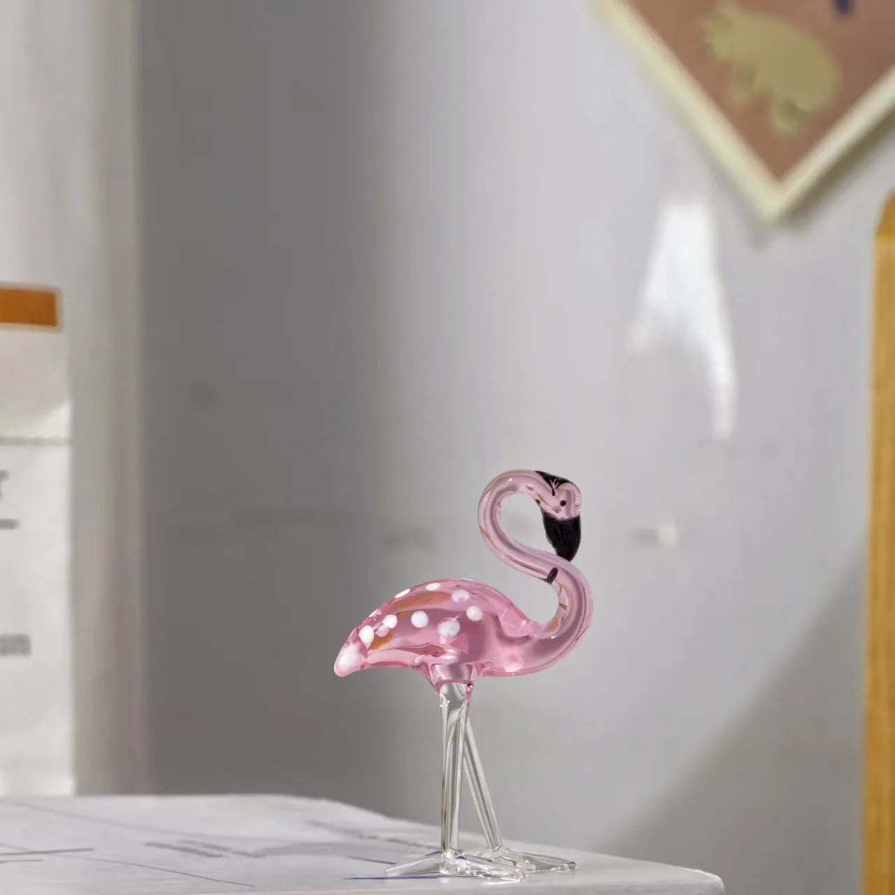 Pink crystal flamingo decorative ornament on table, available in separate or parallel styles.