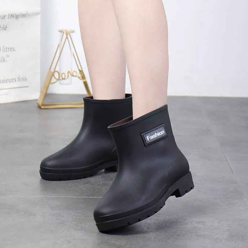 Women's mid-calf PVC rain boot in black, shown with a low heel and optional wool lining.