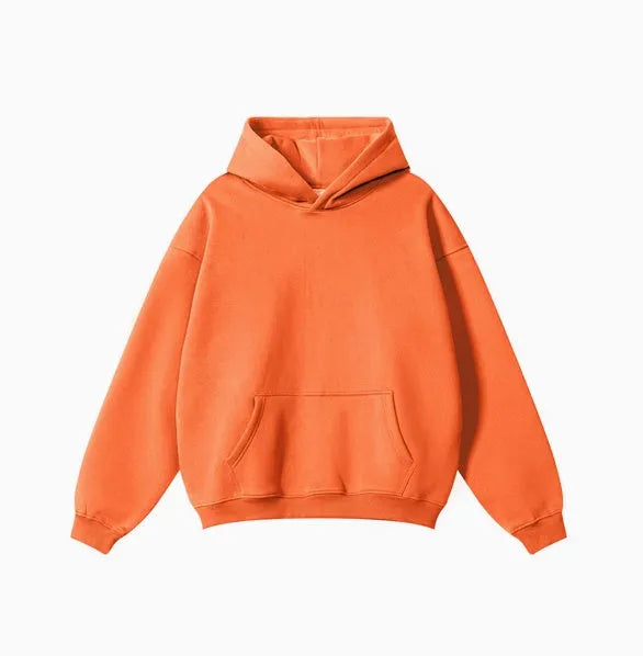 Man wearing a loose-fit cotton terry hooded sweater with drop-shoulder sleeves in a solid colour.