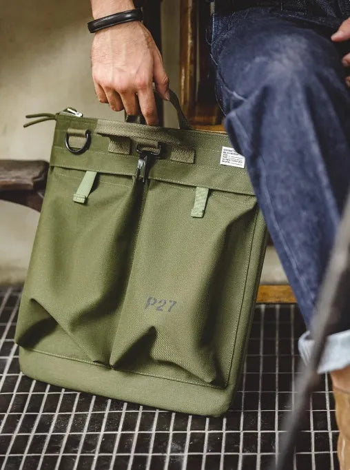 Canvas crossbody messenger bag in military green colour with shoulder strap and hard handle