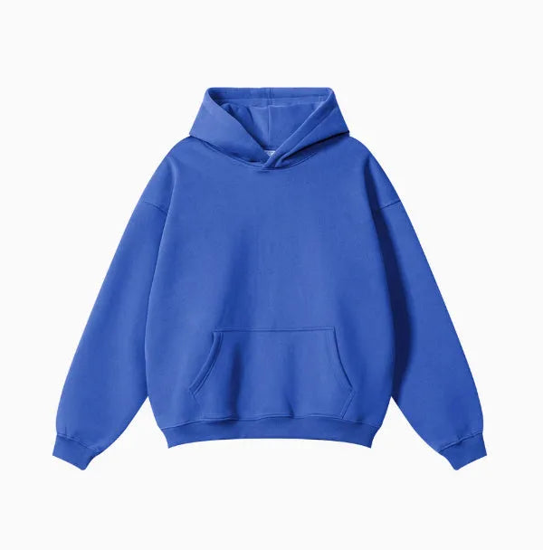 Man wearing a loose-fit cotton terry hooded sweater with drop-shoulder sleeves in a solid colour.
