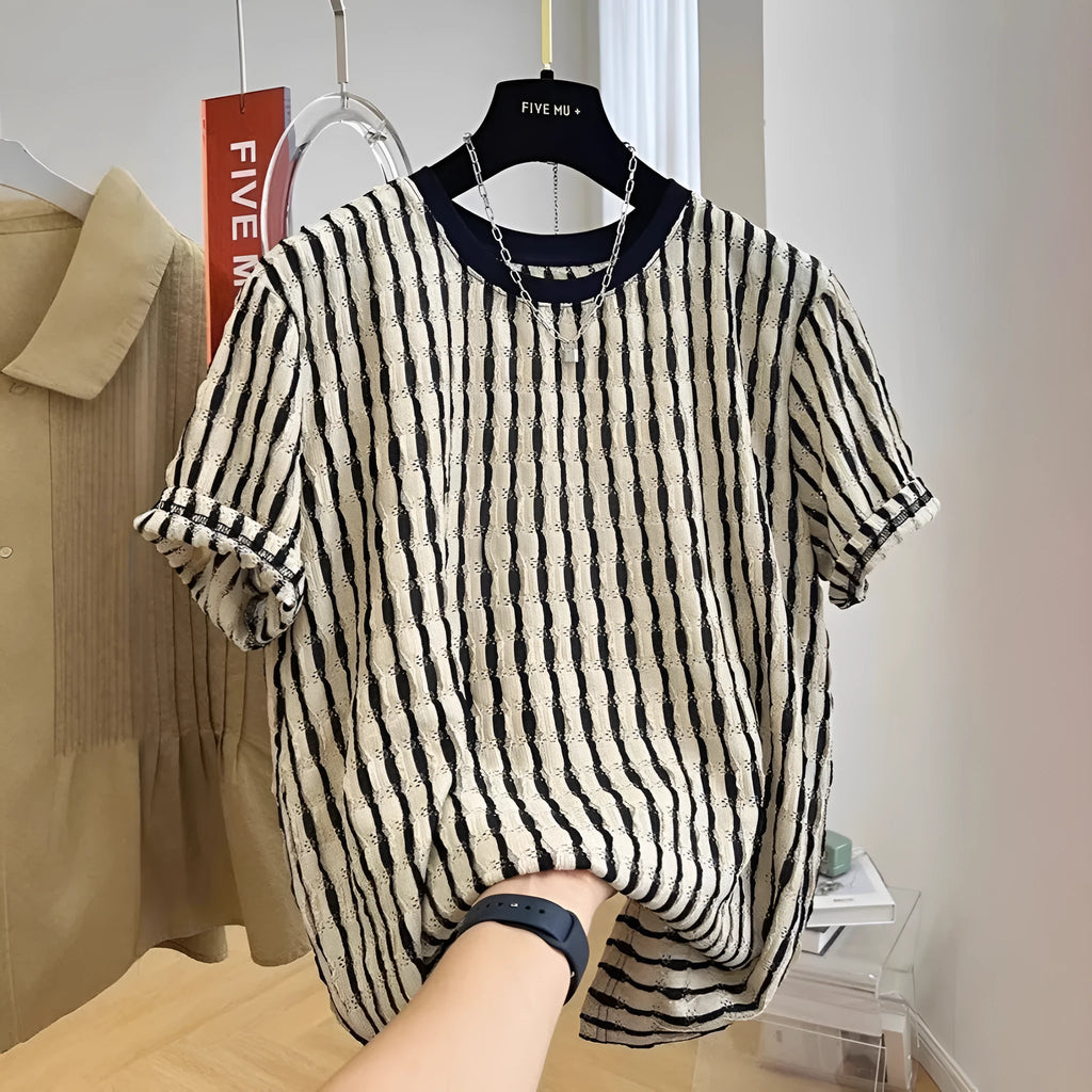 Men's black and white striped short sleeve linen shirt with loose fit pullover style displayed on flat lay