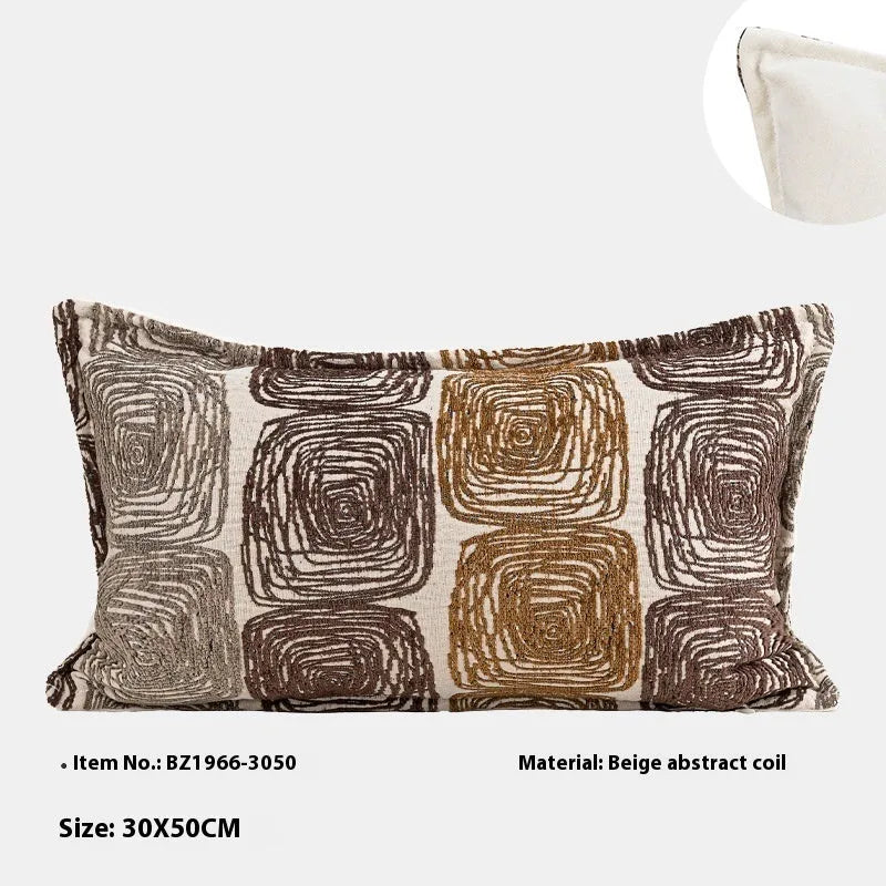 Cream and coffee coloured abstract coil pattern on two pillow sizes: a square cushion and a rectangular bolster.