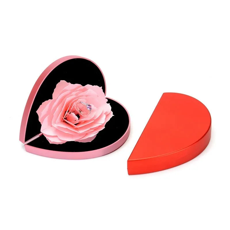 3D Love Box heart-shaped rotating rose flower ring box in red plastic on white background