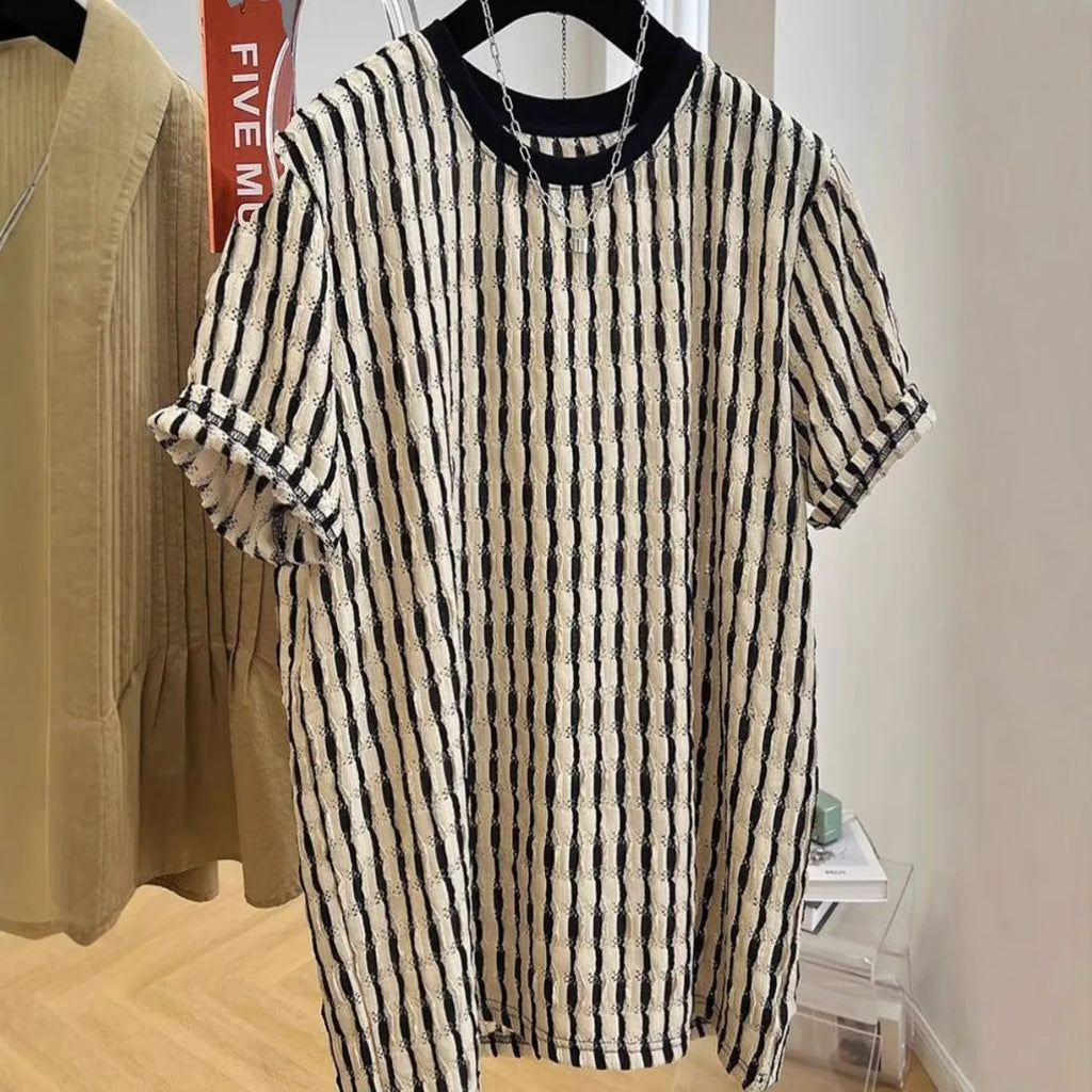 Men's black and white striped short sleeve linen shirt with loose fit pullover style displayed on flat lay