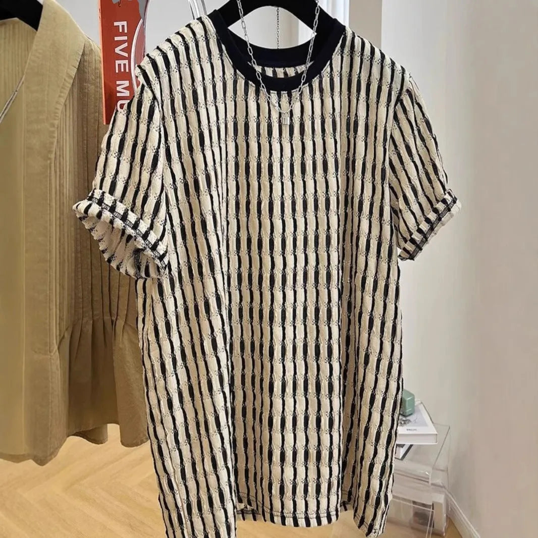 Men's black and white striped short sleeve linen shirt with loose fit pullover style displayed on flat lay