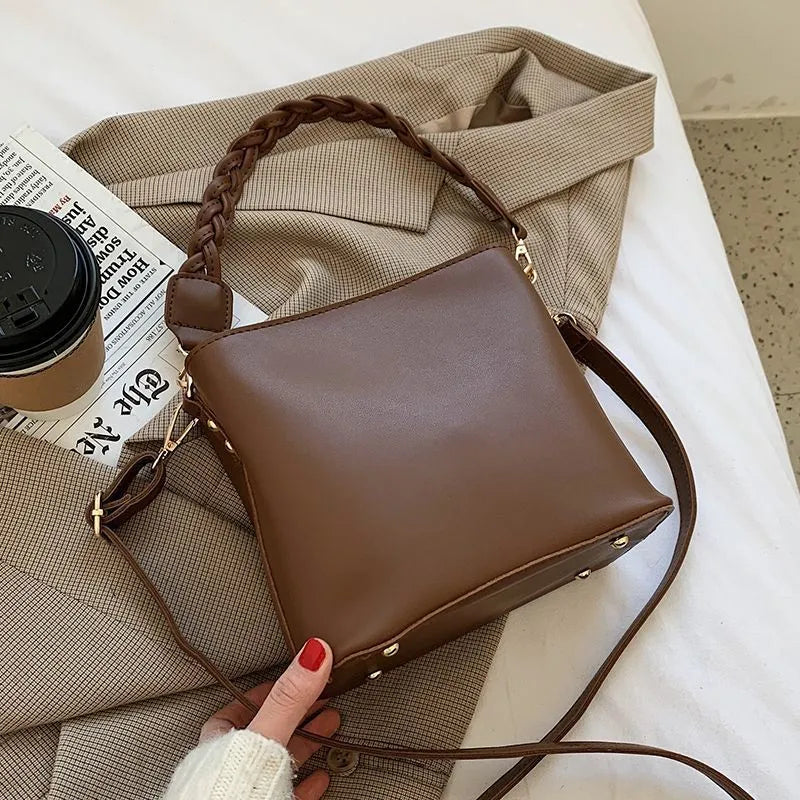 Retro woven PU leather crossbody bucket bag in khaki colour showing underarm design and textured surface