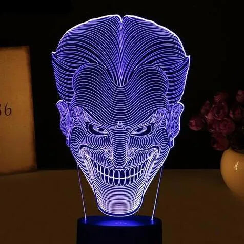 USB-powered 3D acrylic LED table lamp showing seven colour options on a desk