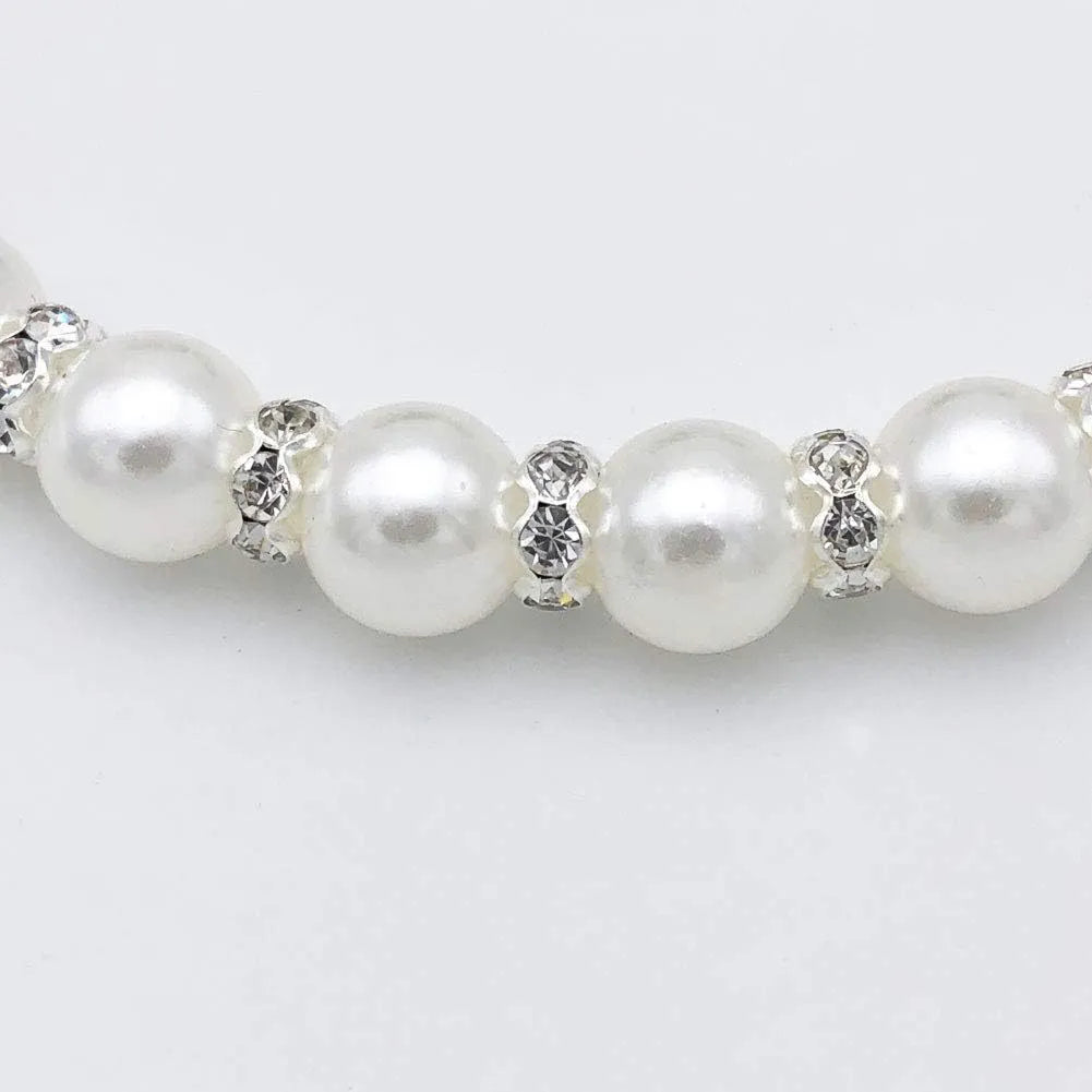 Adjustable diamond dog pearl necklace with rhinestones and ribbon bow in blue, pink, purple, or white.