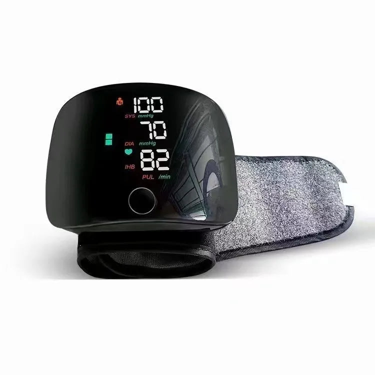 Black digital wrist blood pressure monitor with USB recharge port and display