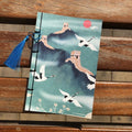 A5 antique wire-bound notebook with retro painting cover, open to show Kraft paper pages