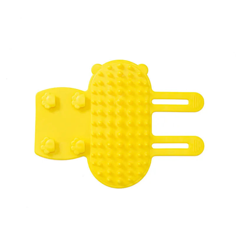 Silicone cat grooming comb with adjustable strap mounted on a table leg, shown in assorted colours.
