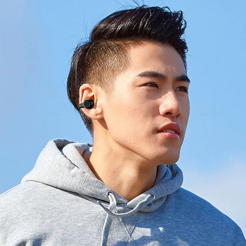 Black and white wireless Bluetooth bone conduction headset with clip-on design for exercise use