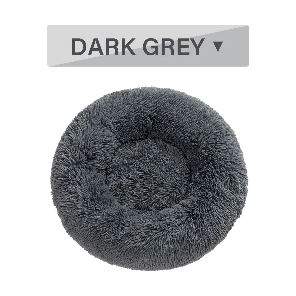Fluffy donut-shaped pet bed in long plush fabric, shown in a light grey colour.