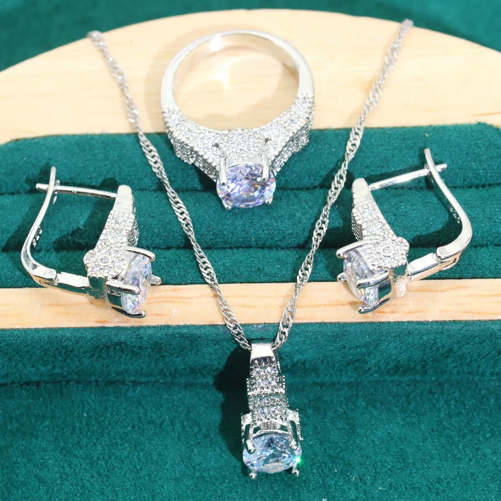 Four-piece bridal jewellery set showing necklace, earrings, ring, and bracelet with zircon alloy pendants