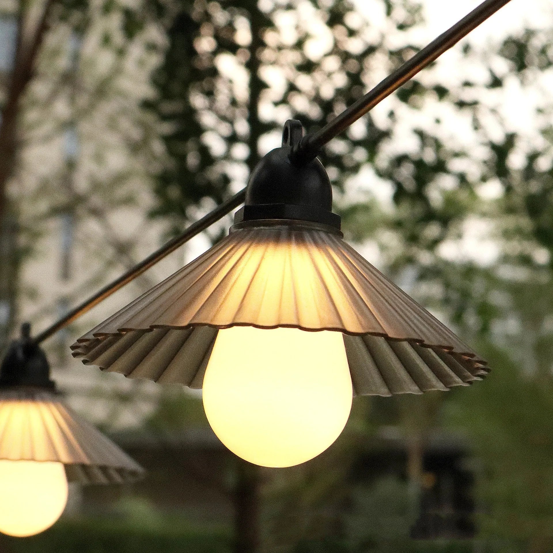 Outdoor LED string lights with flower-shaped globes in various colours including warm white