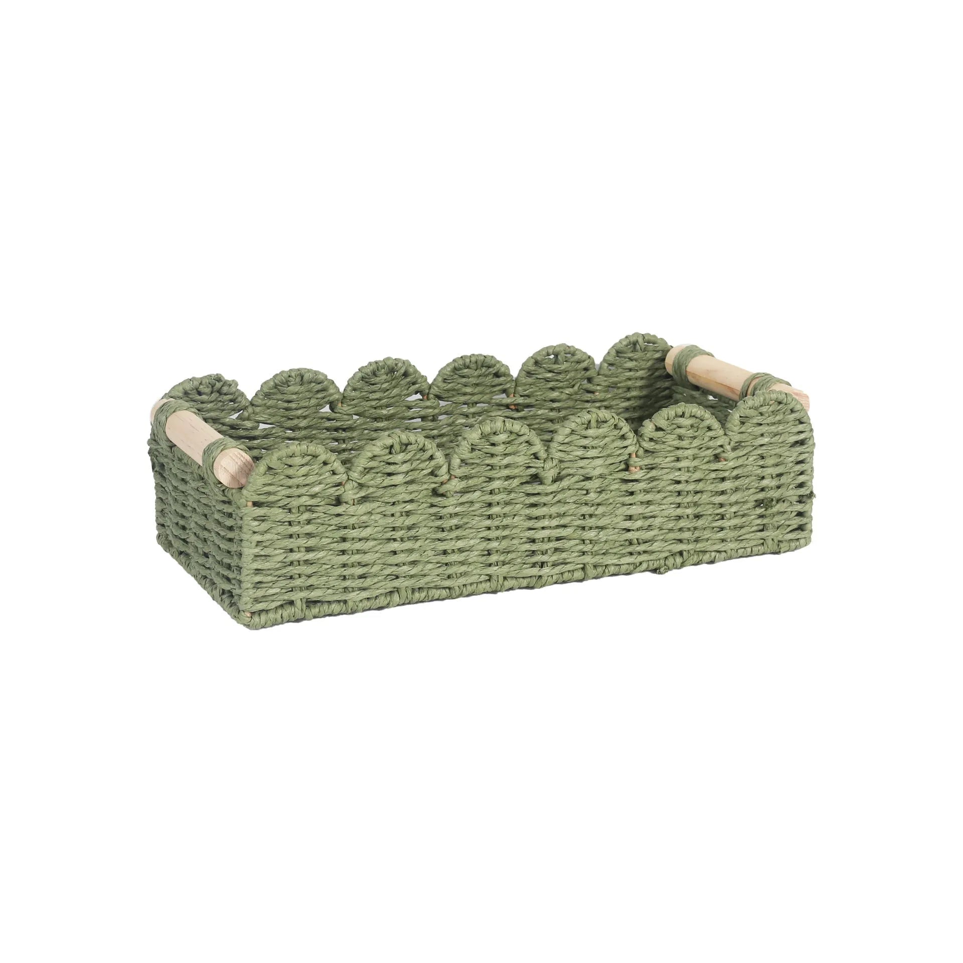 Woven paper storage basket in khaki colour on a desktop, holding remote controls and stationery.