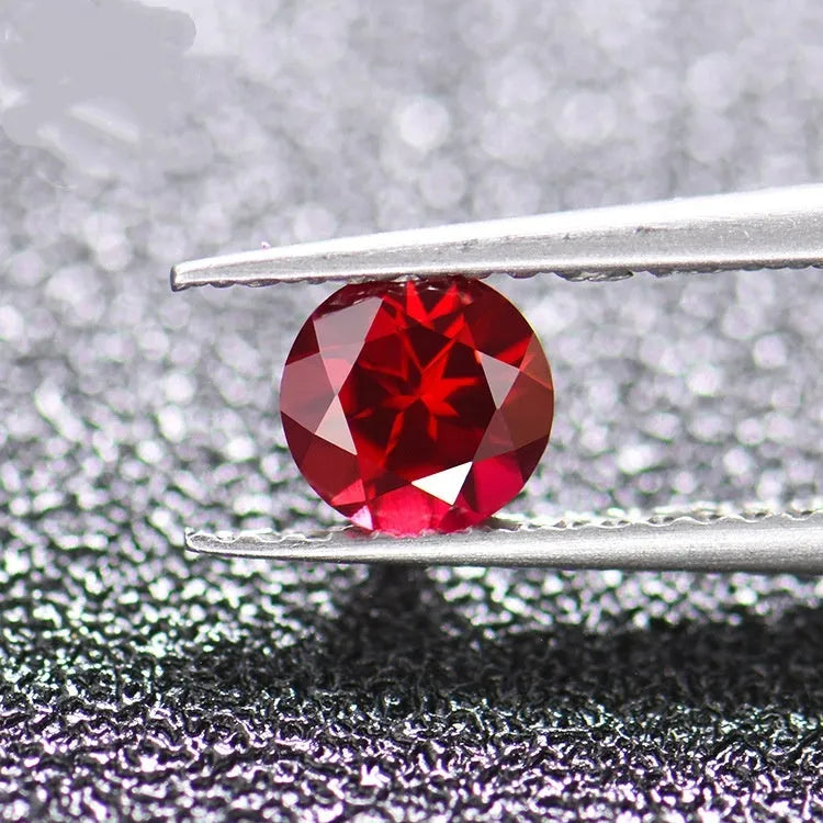 Cultivated pigeon blood red ruby gemstone in round cut on a white background.