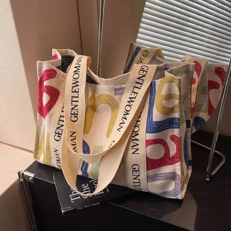Women's large canvas tote bag with printed design options for travel and shopping.