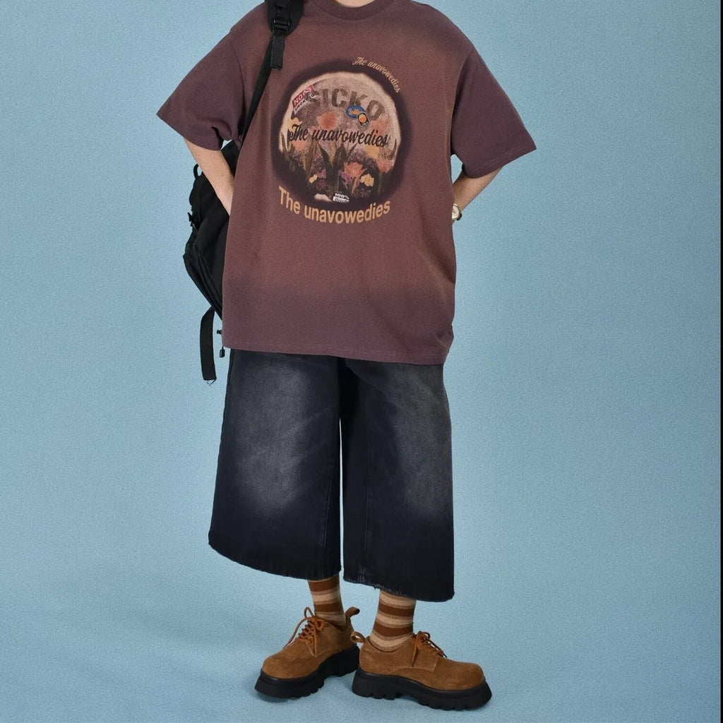 Men's loose fit jeans shorts in blue denim with a straight leg, shown on a model.