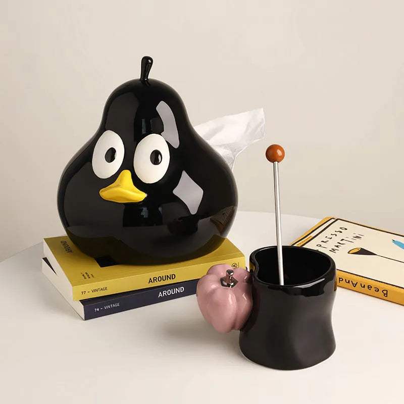 White ceramic pear-shaped tissue box in green or black colour on desktop
