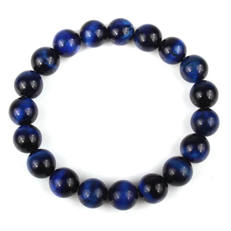 Tiger eye crystal stone bracelet showing round beads available in multiple colours and sizes on a wrist.