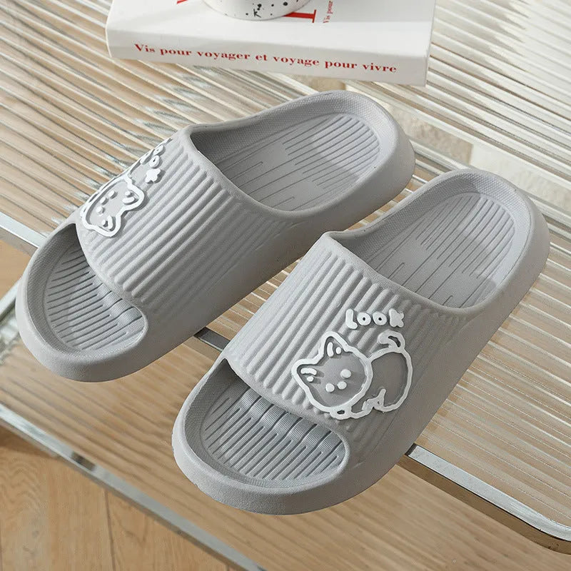 Green EVA platform flip flop slippers with a raised cat design on the upper.
