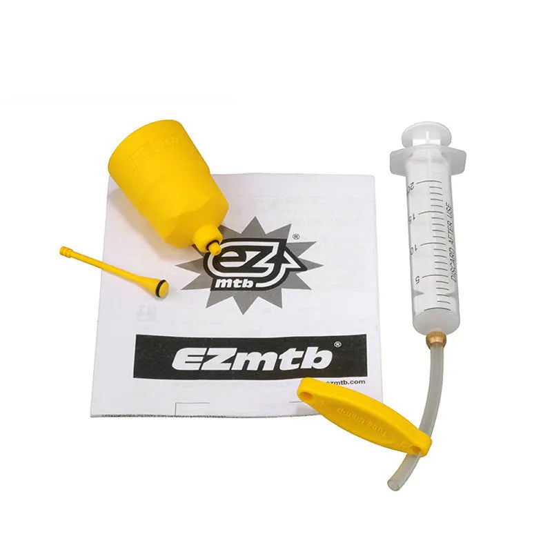 EZmtb bicycle hydraulic brake bleed kit showing syringes, funnels, adapters, and wrenches on a table