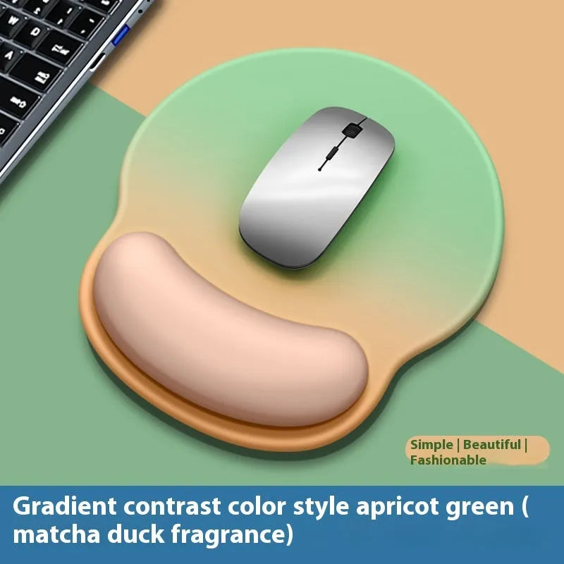Silicone mouse mat with wrist rest in gradient colour pattern on desk