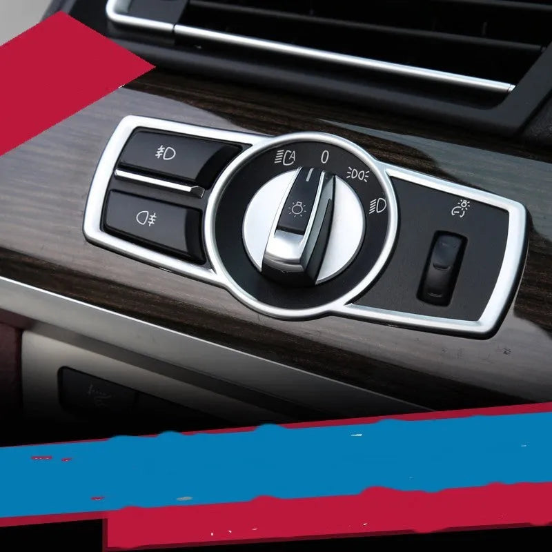 Silver ABS plastic decorative interior sticker for BMW 5 Series headlight switch frame.
