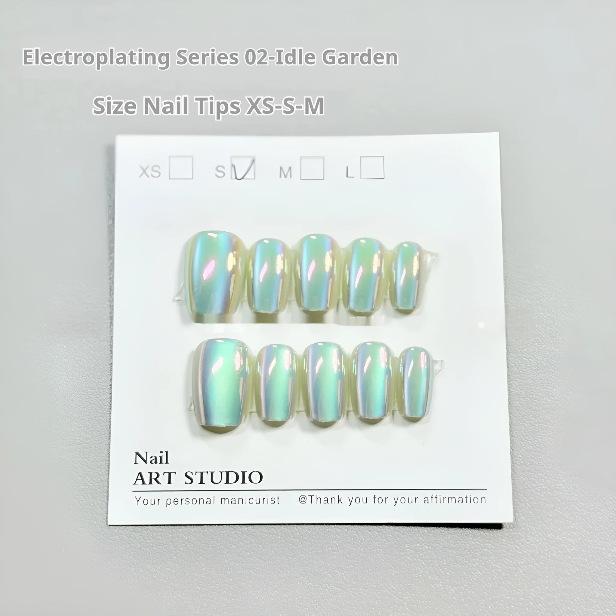 Set of electroplated Cat's Eye press-on false nails in short ladder length on a nail wheel.