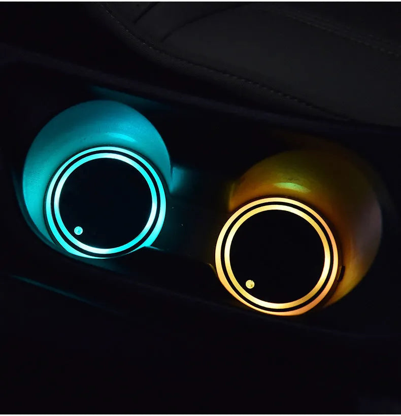 Colourful LED light-up car coaster with solar panel and USB cable on a car seat
