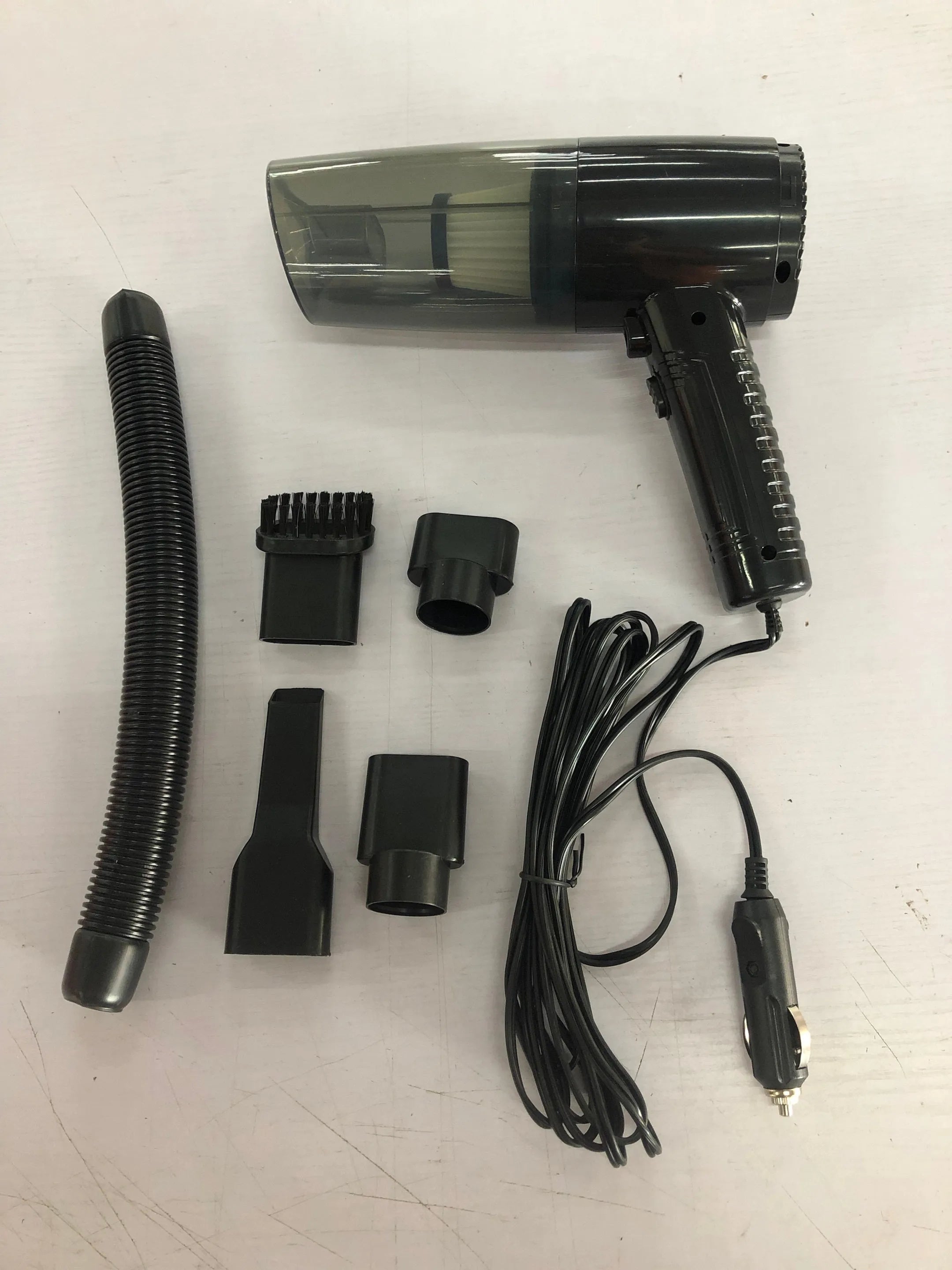 Black and white portable car vacuum cleaner with accessories on a 5-metre power cord.