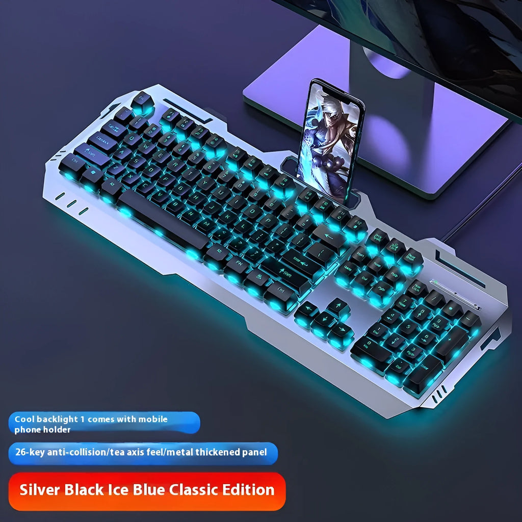 Aluminium gaming keyboard with volume knob, shown in metal grey with RGB lighting alongside optional macro mouse and headset.