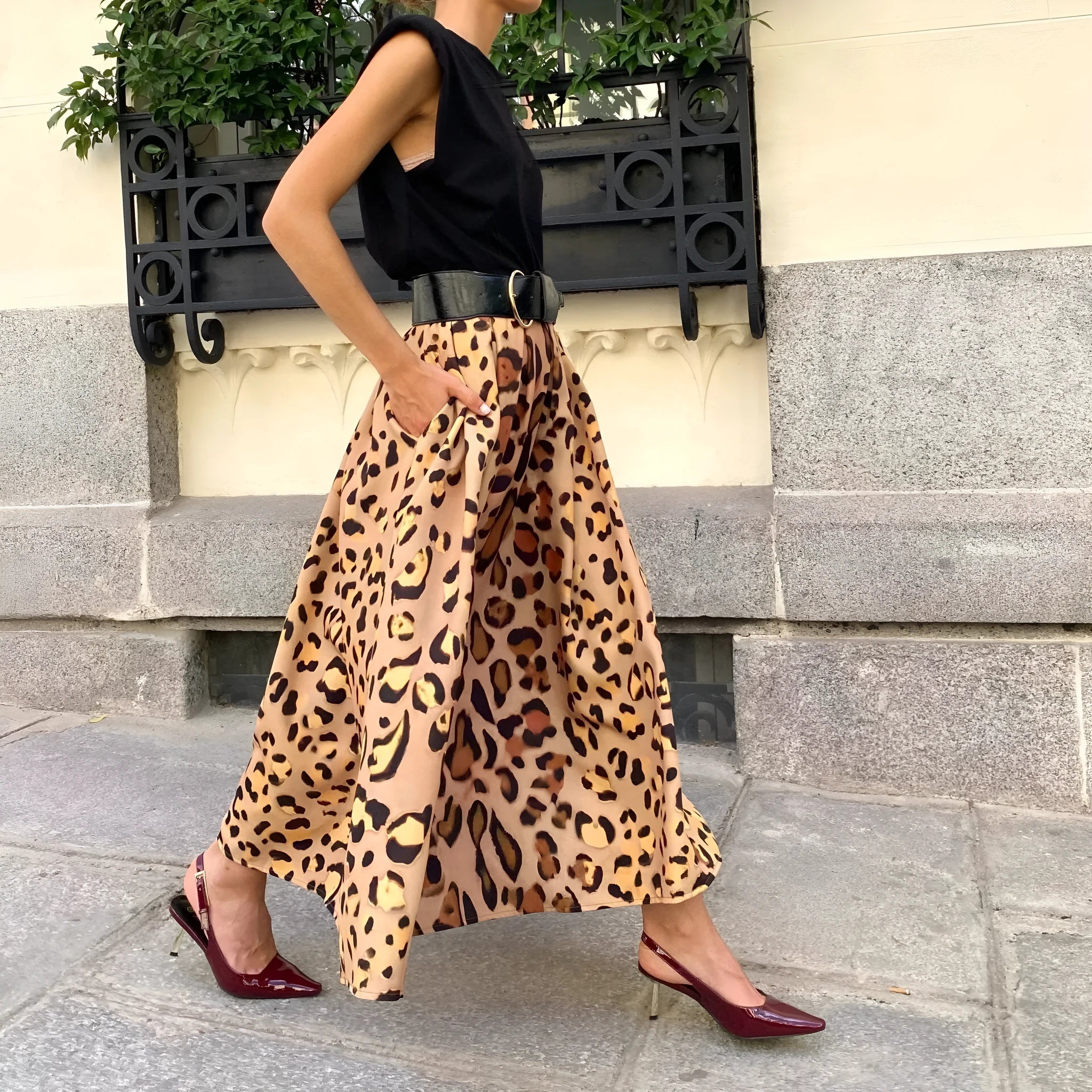 Brown leopard print women's A-line long skirt with a big hem on a hanger.