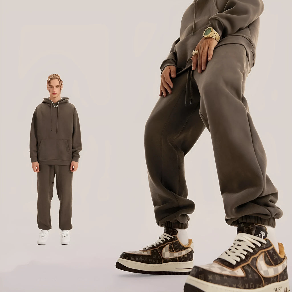 Men's dark brown velvet sweatpants with elastic waistband and banded ankle cuffs on hanger