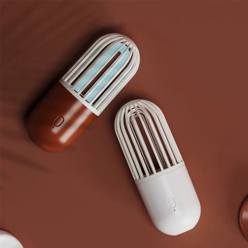 Portable capsule ultraviolet disinfection lamp in black, brown, green or white with display showing 52x52x136mm dimensions