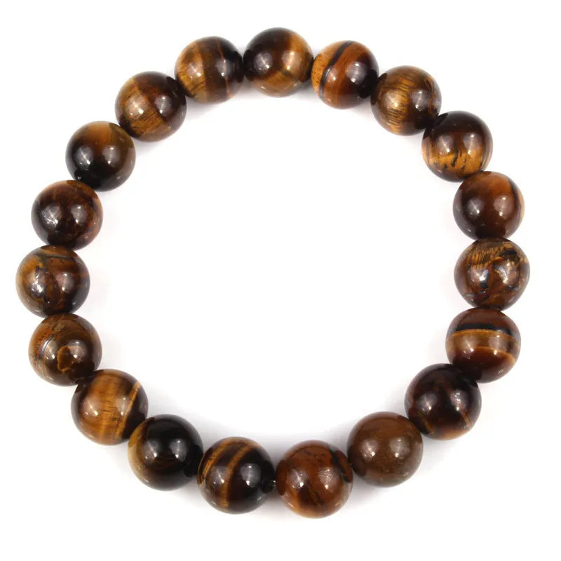 Tiger eye crystal stone bracelet showing round beads available in multiple colours and sizes on a wrist.