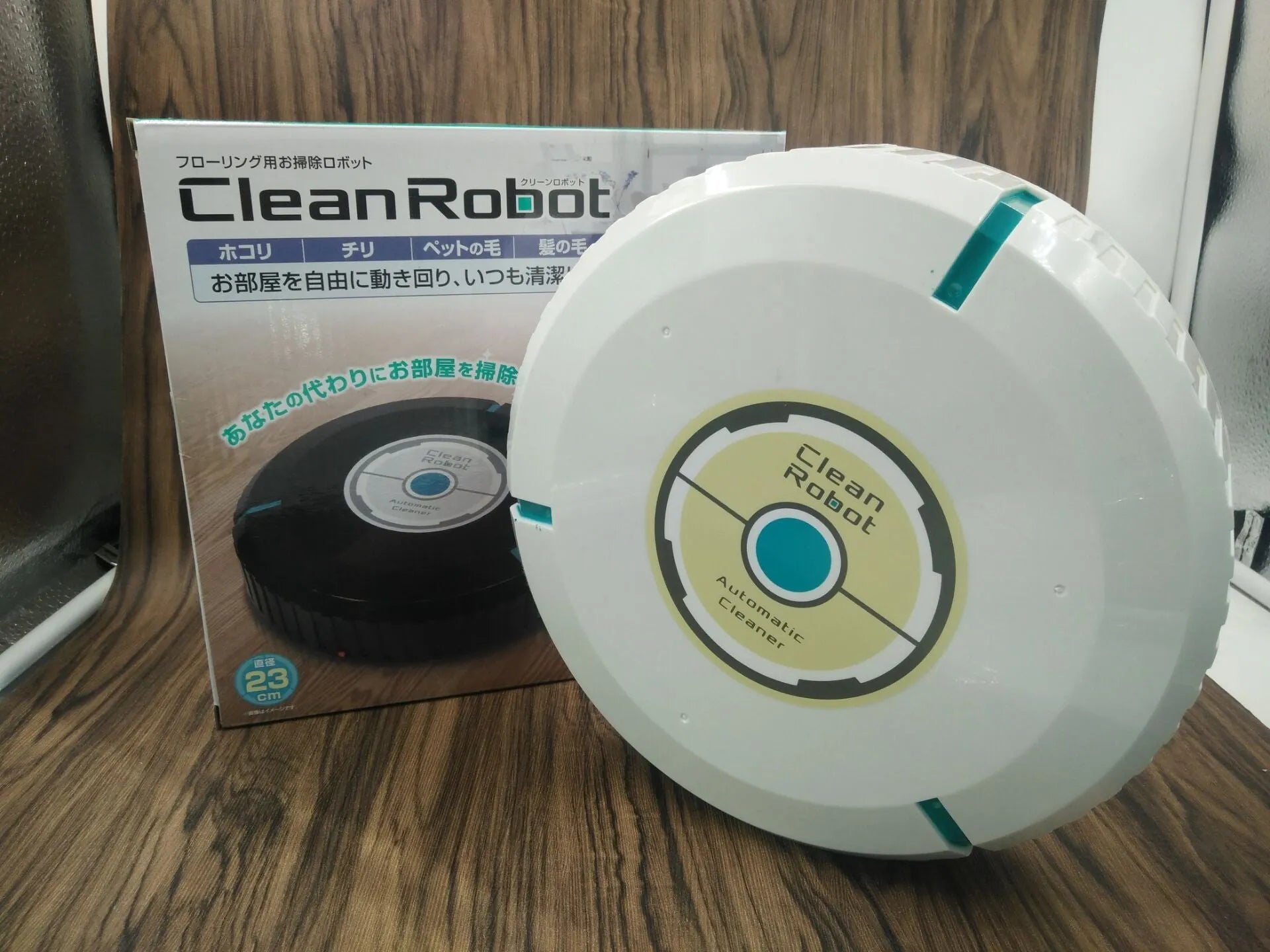 Black or pure white automatic floor sweeping robot with 23cm diameter on wooden floor