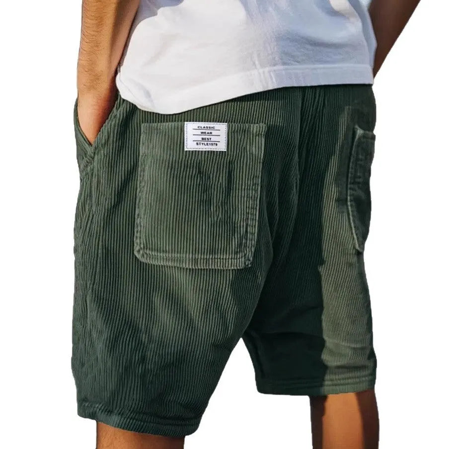 Men's grey corduroy shorts with embroidered detail on multiple pockets, laid flat.