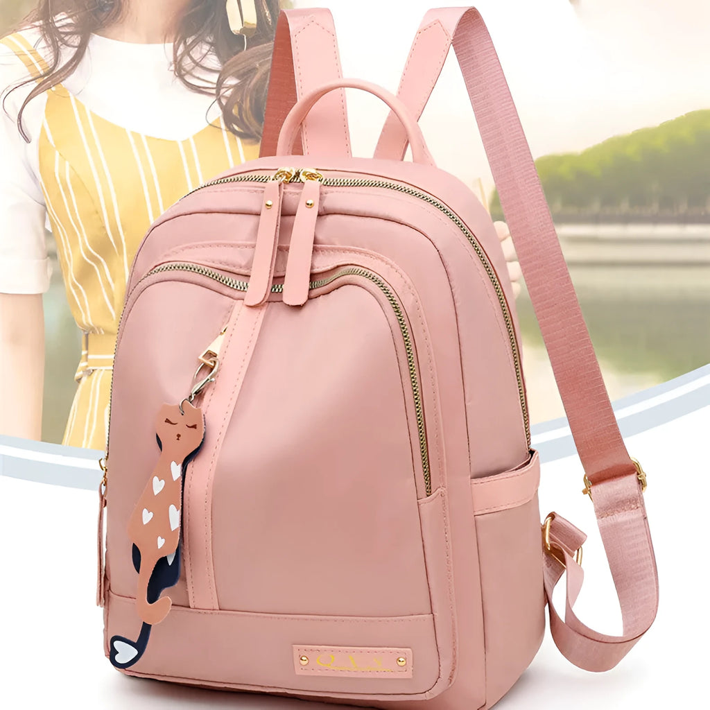 Black nylon casual travel backpack with double shoulder straps, external pockets, and a soft handle on a solid background.